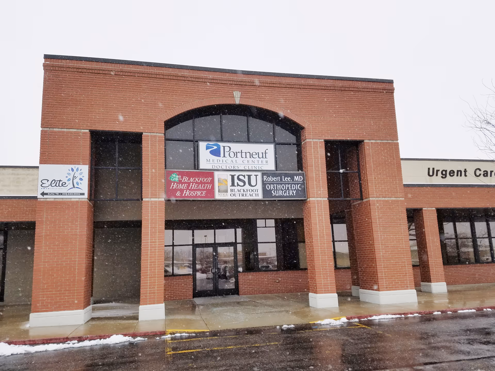 Brick medical plaza facade with storefronts and signs, including Blackfoot Home Health and Hospice.