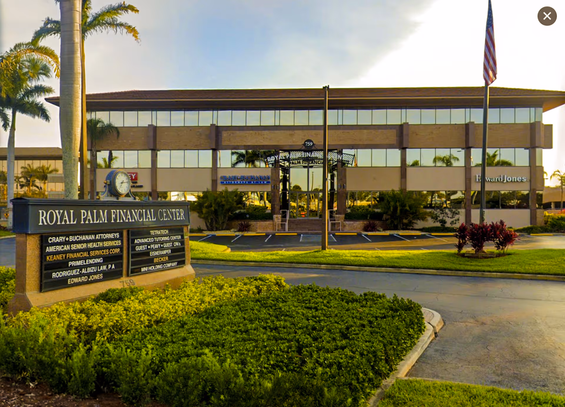 Exterior view of a modern two-story building with a Royal Palm Financial Center sign.