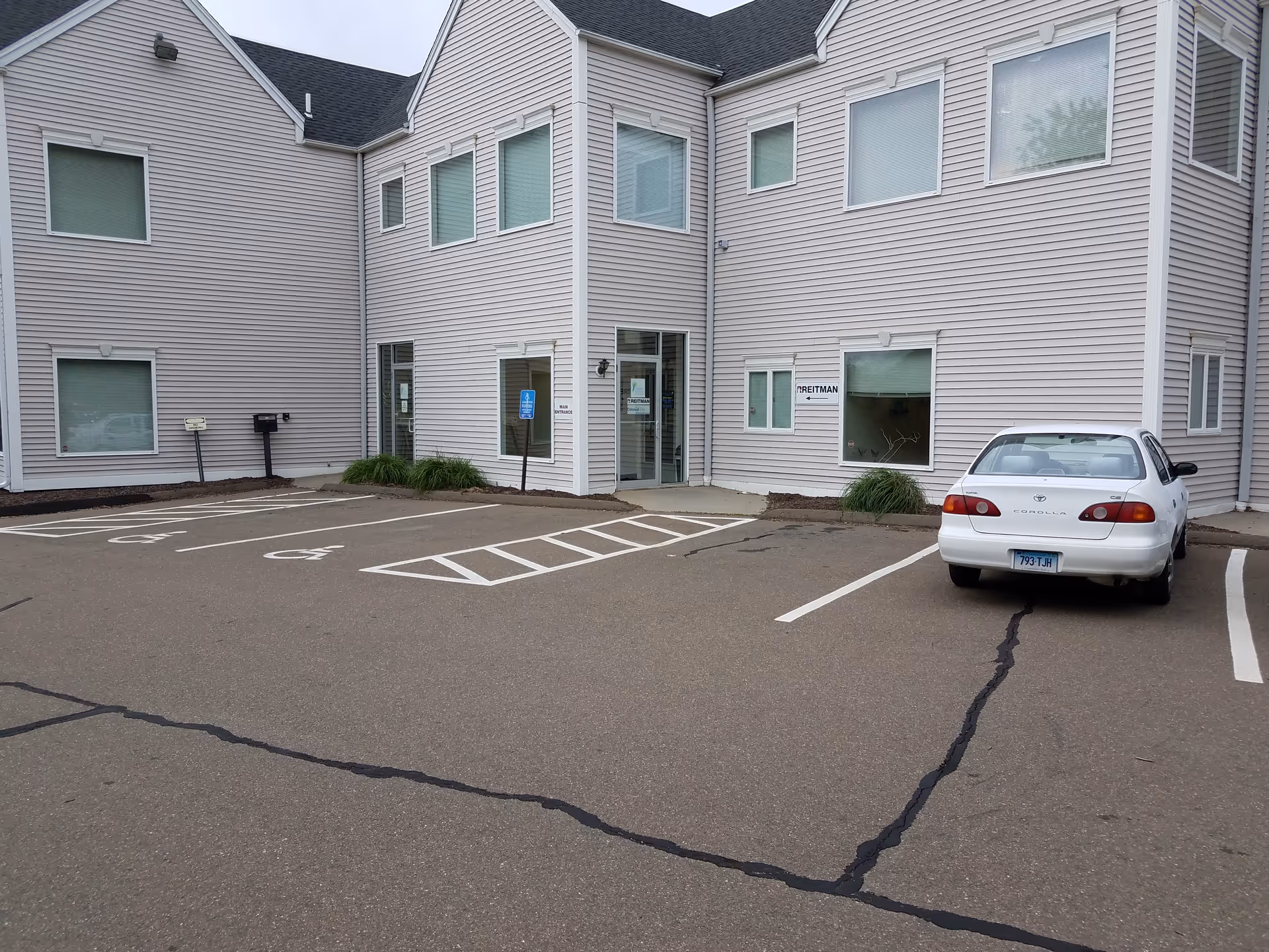 Exterior view of Home Health Care Services Corporation building with a marked parking lot.