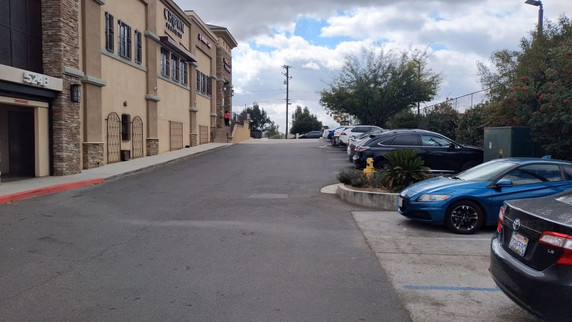 Exterior view of Perris Urgent Care building with a sloped driveway and parked cars.
