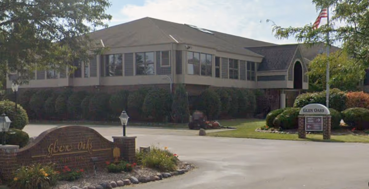 Front view of Glen Oaks senior living facility with curved entrance and manicured landscaping.