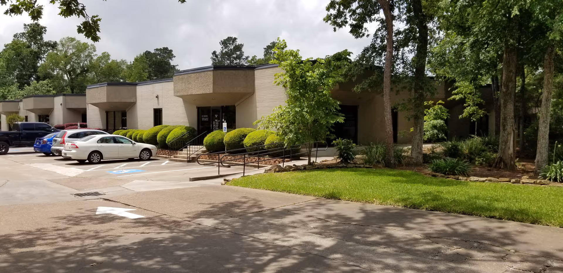 Exterior view of Continuity Care Home Health building with parked cars and landscaped entrance.