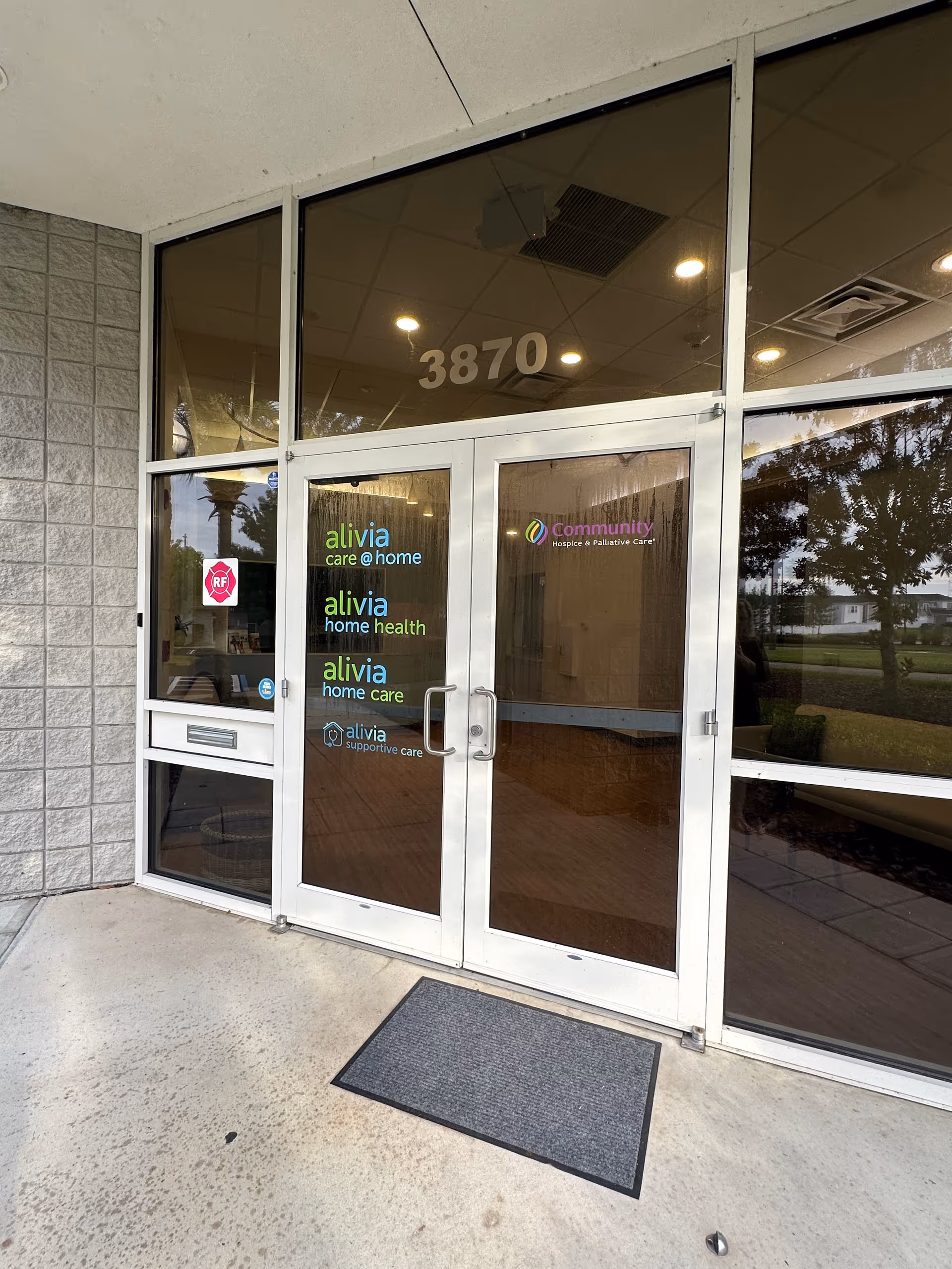 Front entrance of hospice facility with glass doors and 3870 address visible.