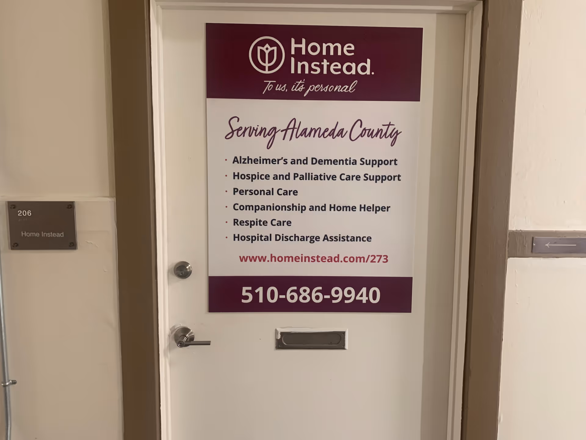 Indoor hallway door with Home Instead sign and room 206 plaque.