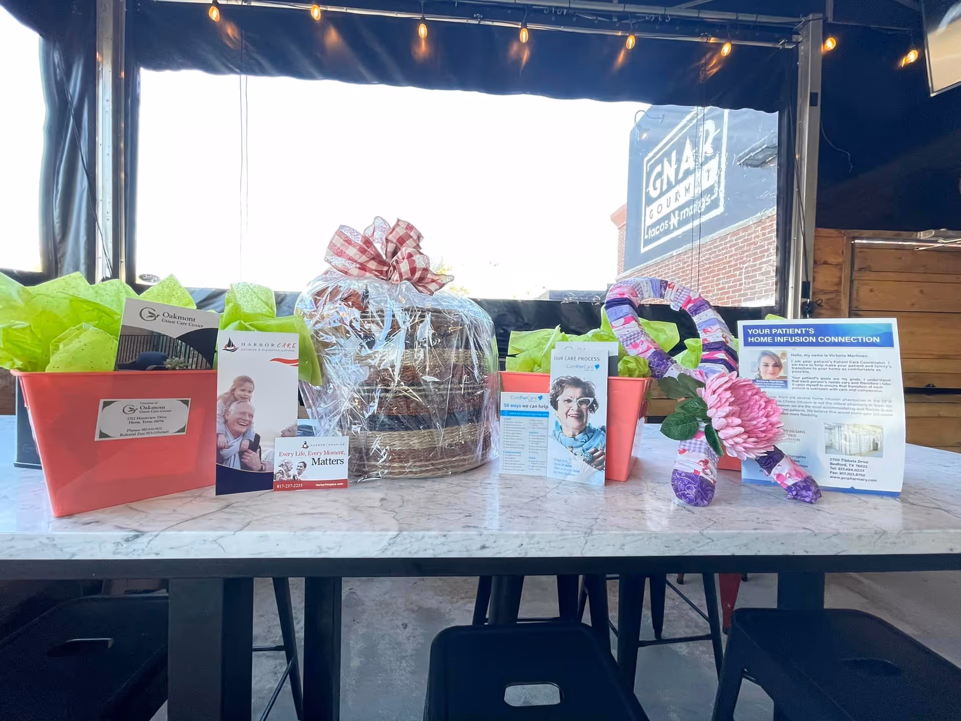 Gift baskets and promotional brochures arranged on a marble table at ComForCare Home Care Irving.