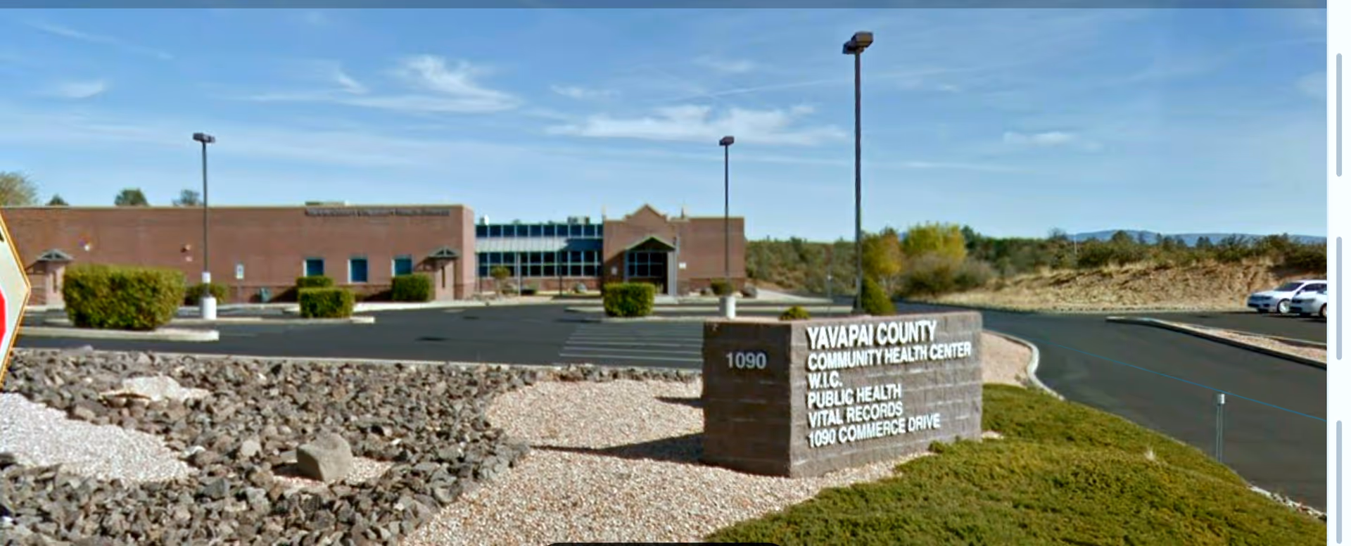 Exterior view of Yavapai County Community Health Services facility with sign and parking.