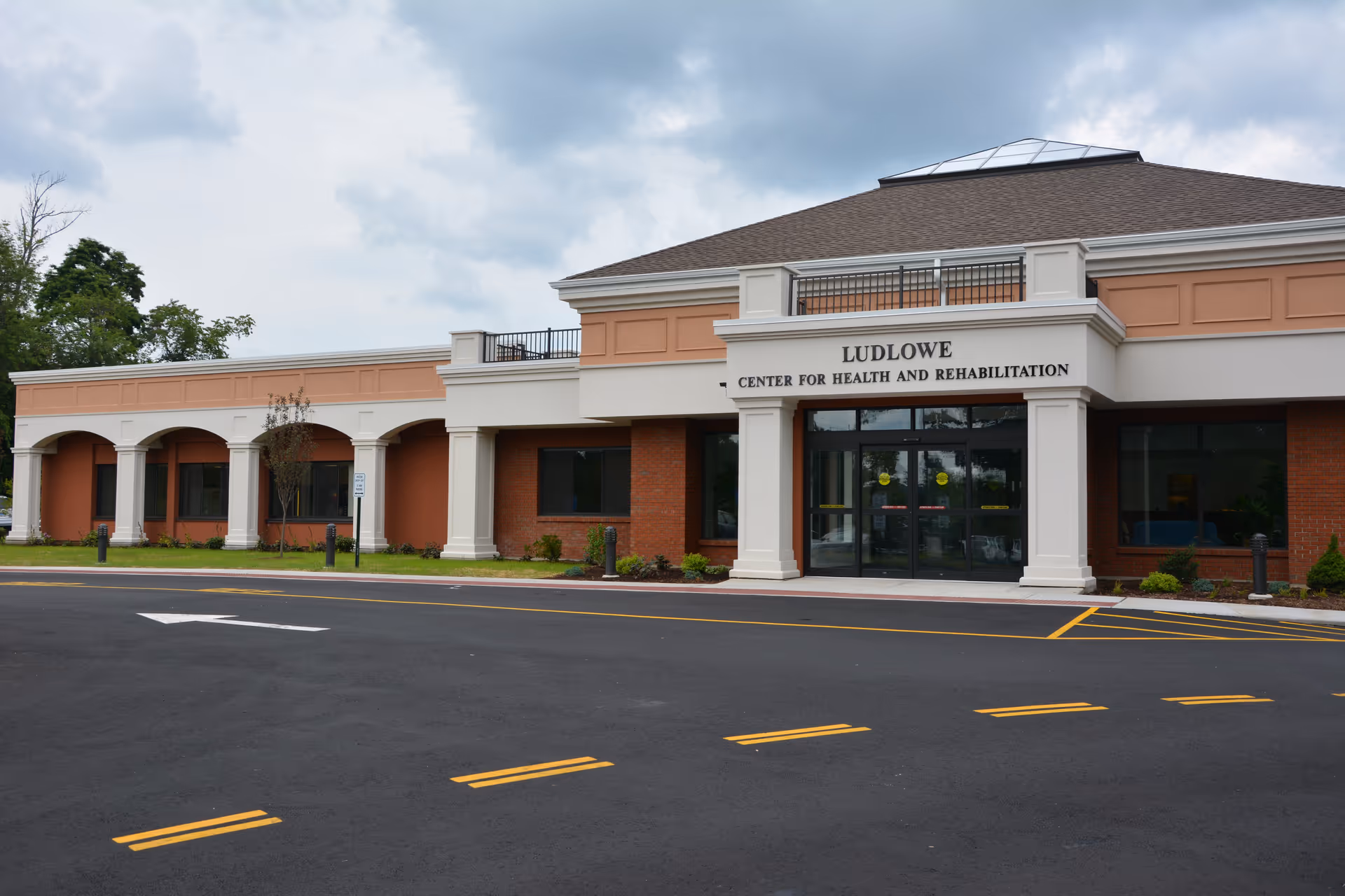 Front exterior of Ludlow Center for Health and Rehabilitation with parking.