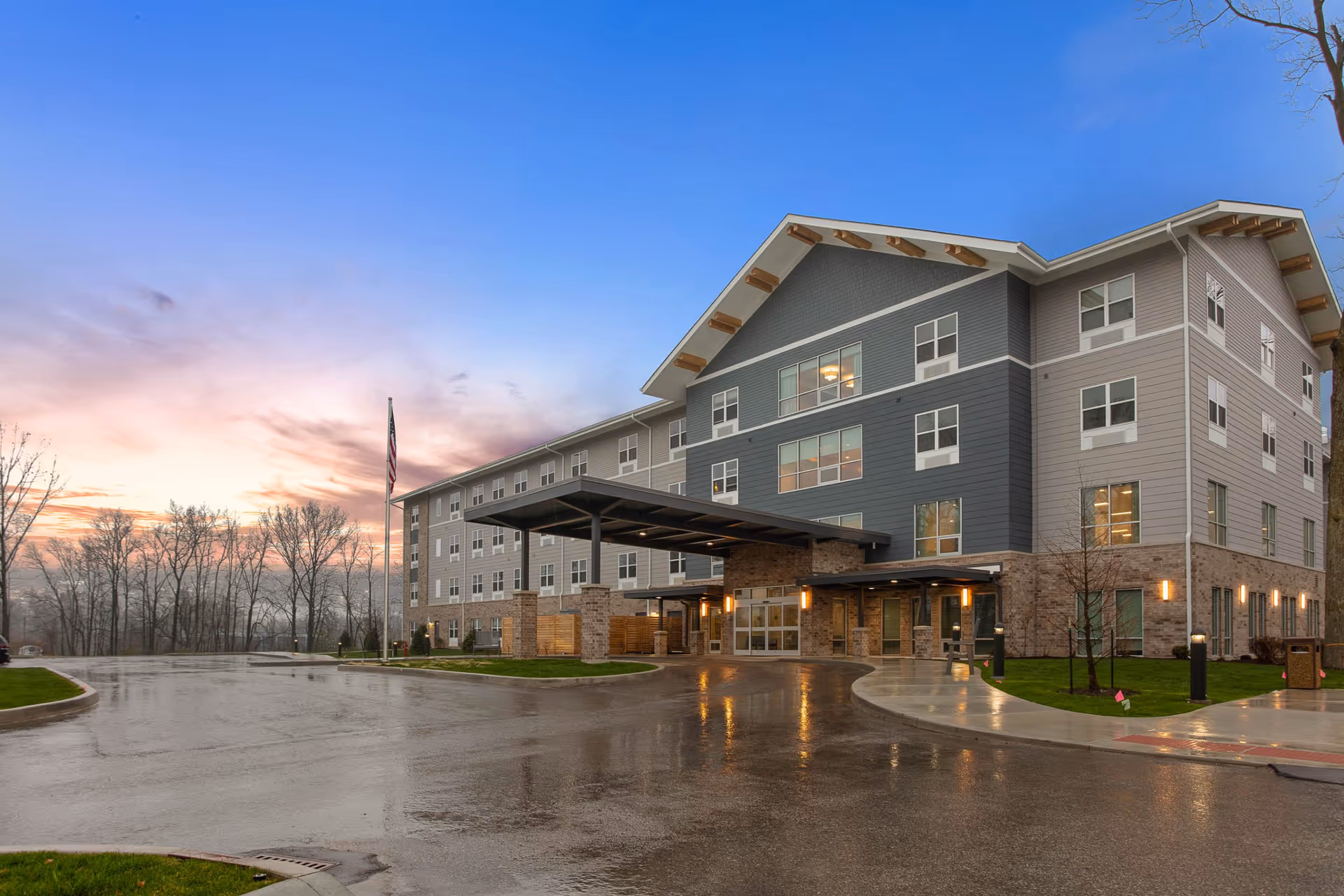 Exterior view of Silver Birch of Fort Wayne, a multi-story senior living facility with entrance canopy.
