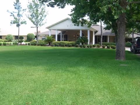 Front exterior view of Columbus Oaks Healthcare Community with a green lawn and entrance canopy.