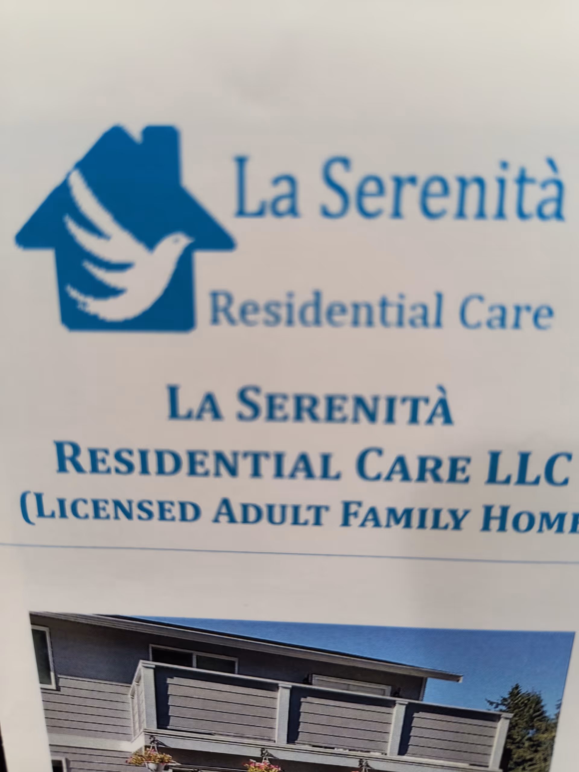 Signage for La Serenità Residential Care with logo and exterior building photo.