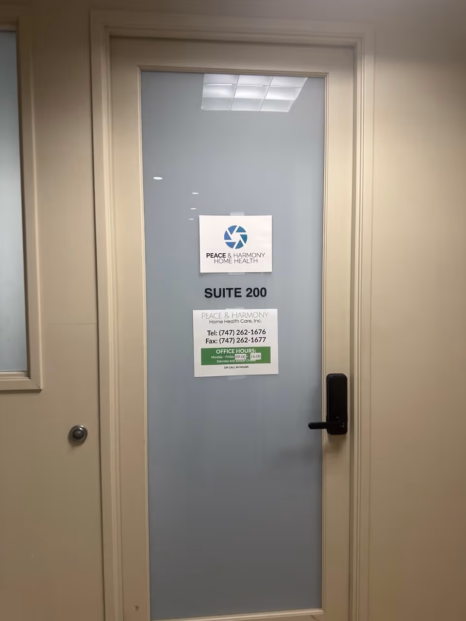 Interior door marked Suite 200 with Peace & Harmony Home Health signs.