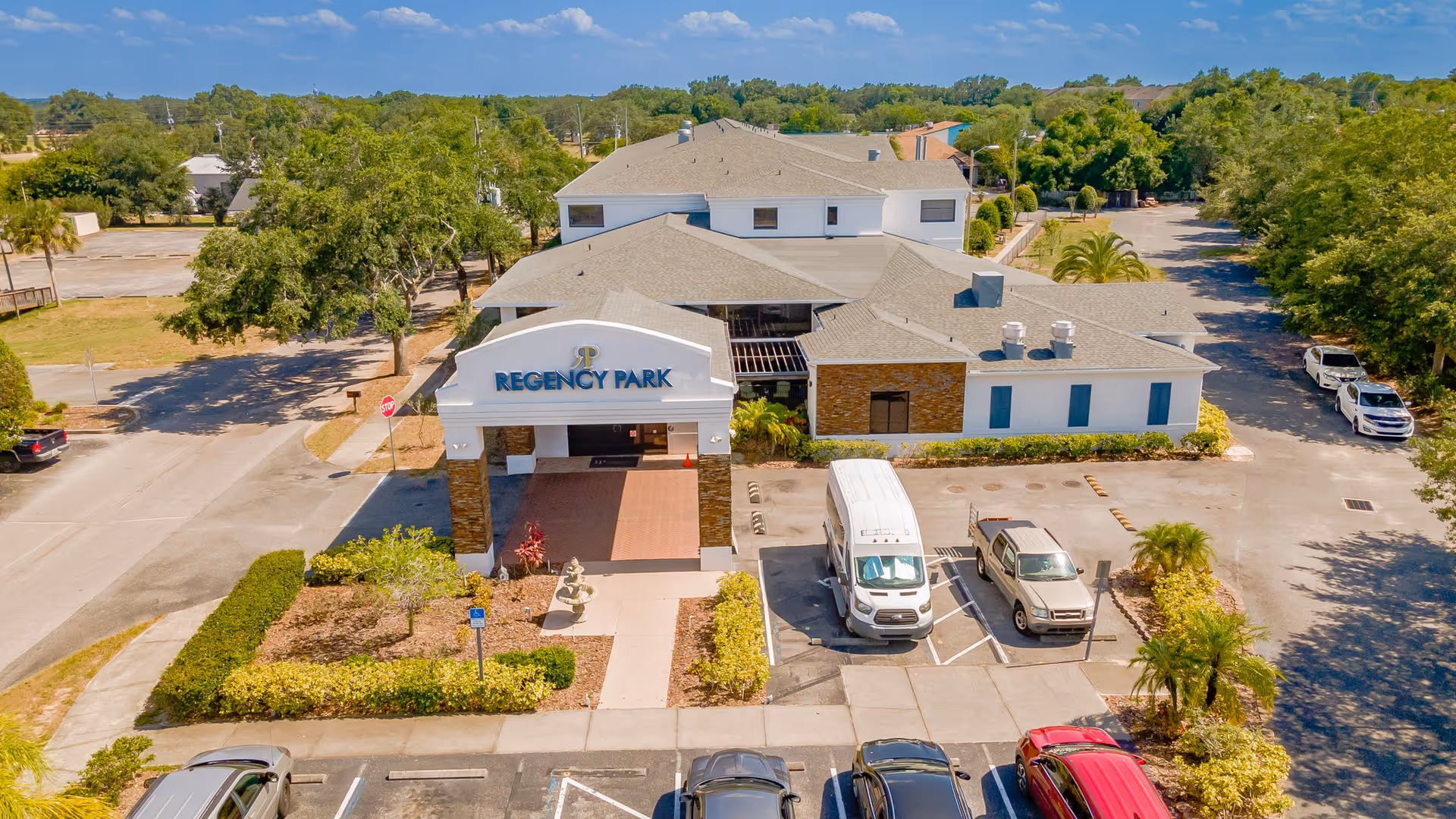Aerial view of Regency Park Assisted Living & Memory Care building with adjacent parking.
