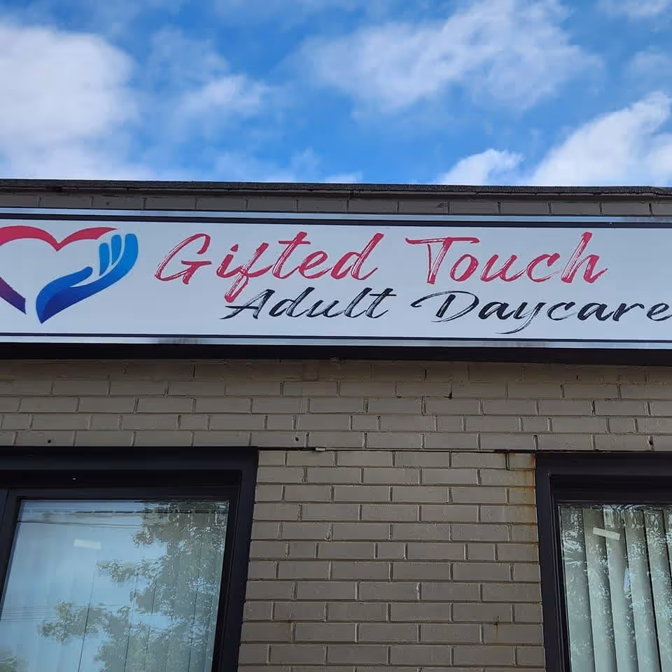 Brick exterior with a Gifted Touch Adult Daycare sign above windows.