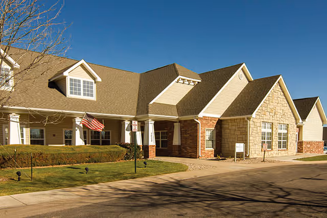 Exterior view of Brookdale Fort Collins Assisted Living entrance with an American flag.