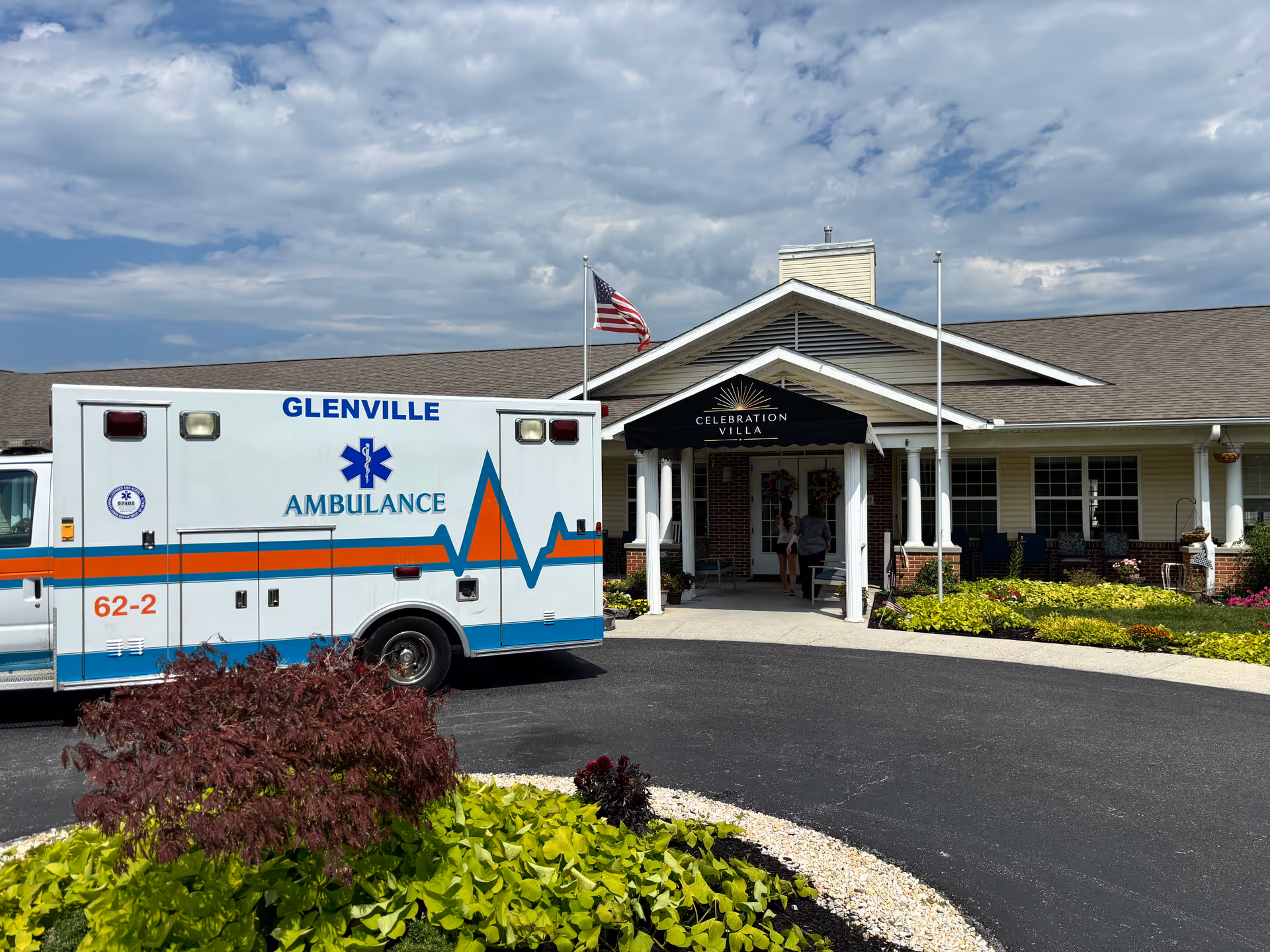 Front view of Celebration Villa entrance with an ambulance parked outside.