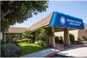 Exterior view of Anaheim Terrace Care Center entrance with blue awning and landscaping.