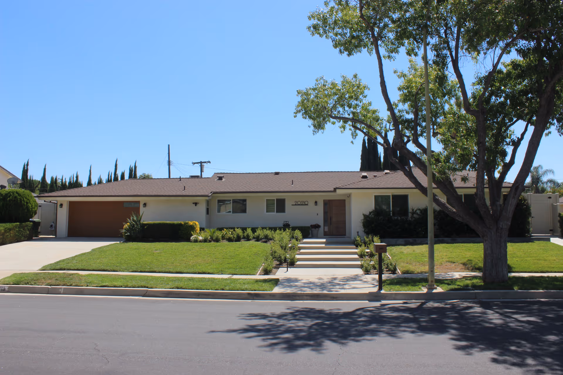 Chatsworth Assisted Living single-story building with a driveway, steps, and a shaded front yard.