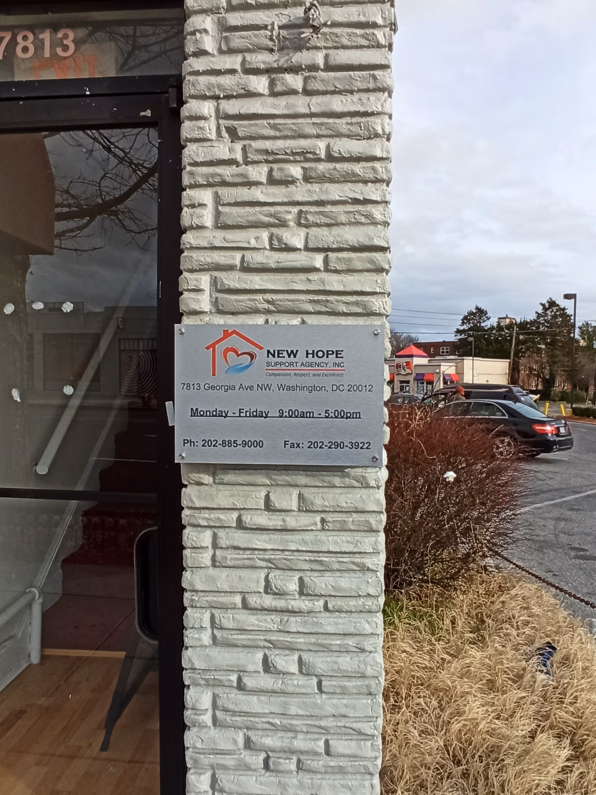 Exterior view of a brick building with a New Hope Support Agency sign.