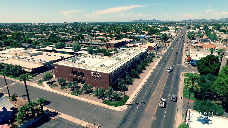 Aerial view of the Hospice of the Valley building along a busy street.