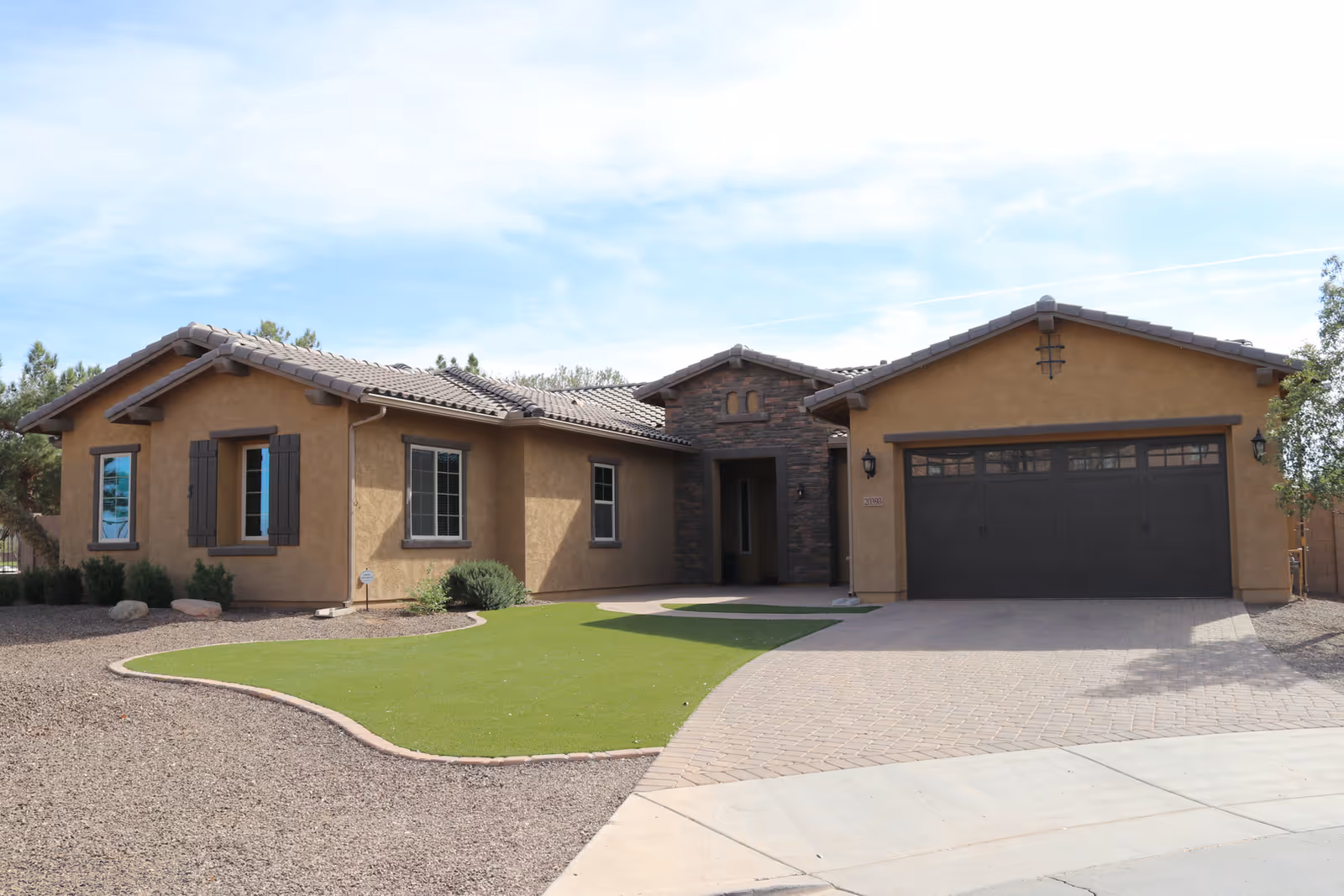 Front exterior of Eden Estates Assisted Living: a single-story tan stucco building with a two-car garage.