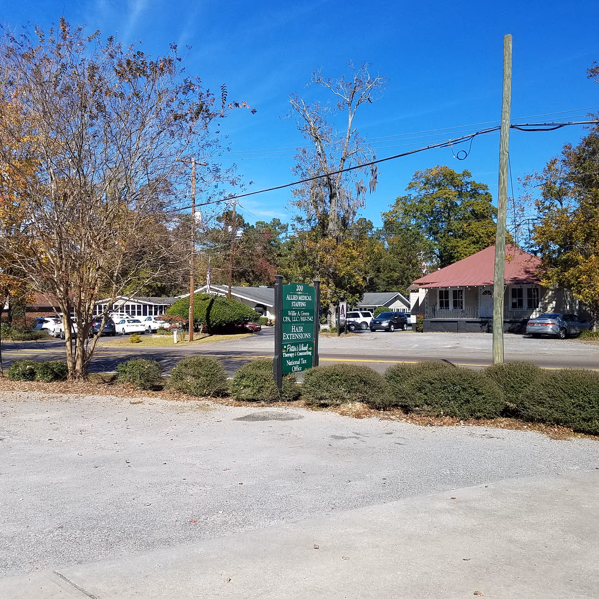 Exterior view of Allied Medical Staffing - Home Care/Nursing facility with sign and parked cars.
