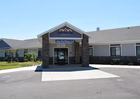 Exterior view of Hope Stay Memory Care entrance with stone pillars