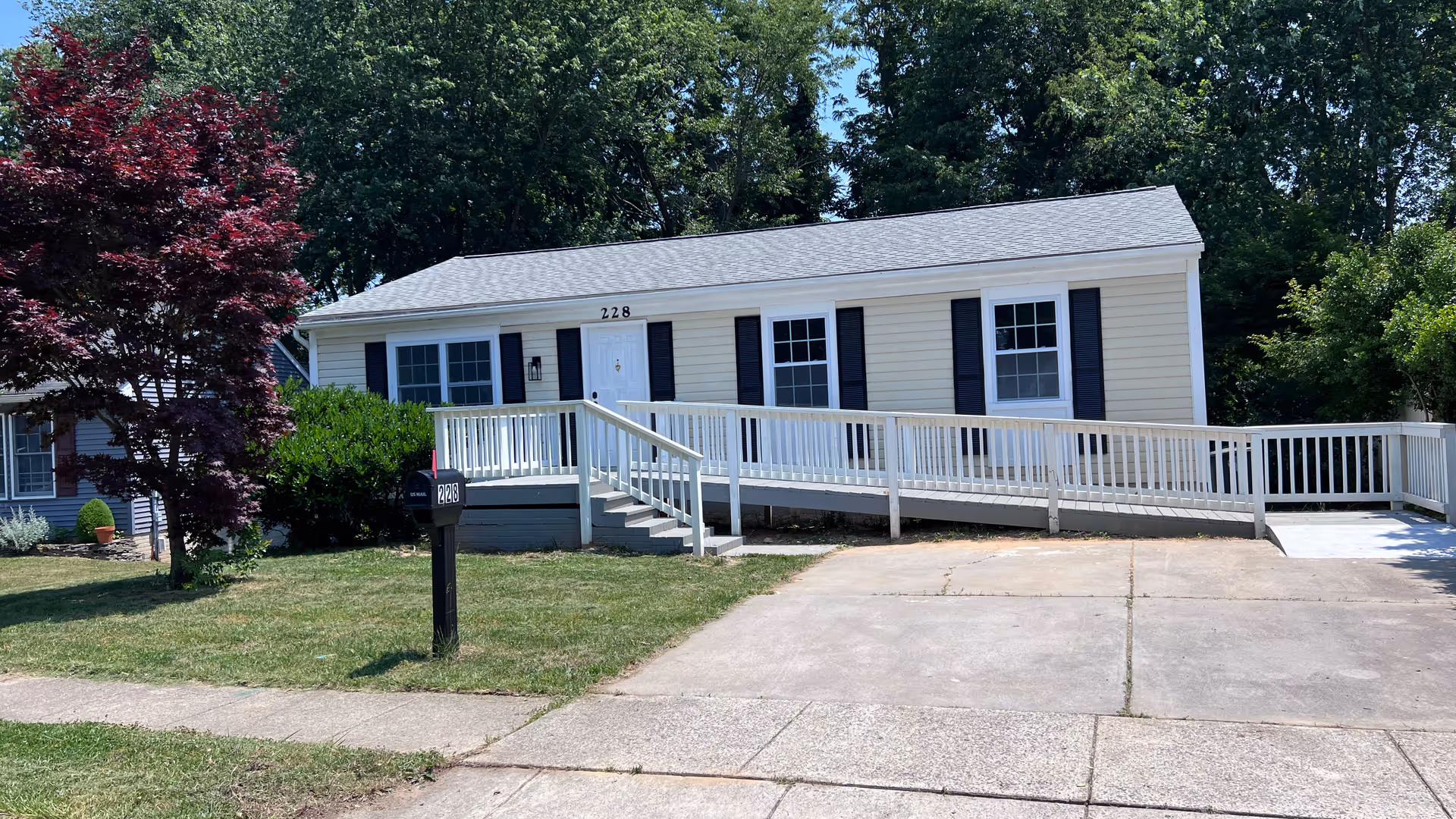 Single-story senior living facility with a white ramp leading to the front entrance.