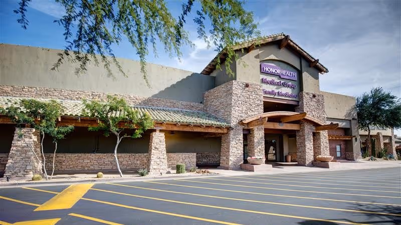 Exterior view of HonorHealth building with stone facade and covered entrance.