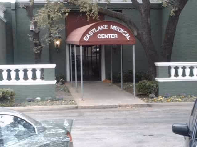 Exterior entrance of Eastlake Medical Center with a canopy, walkway, and surrounding greenery.