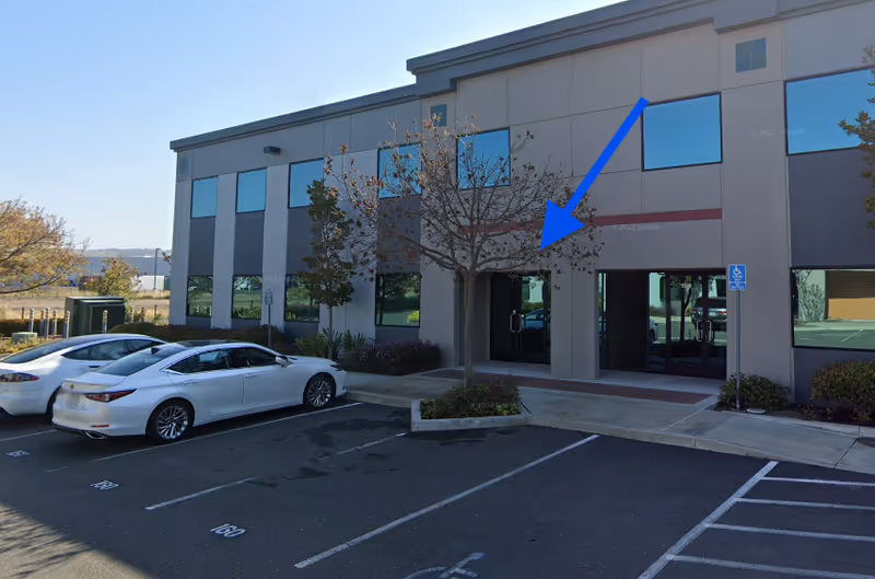 Kadence Healthcare exterior building with entrance doors, parking lot, and trees.