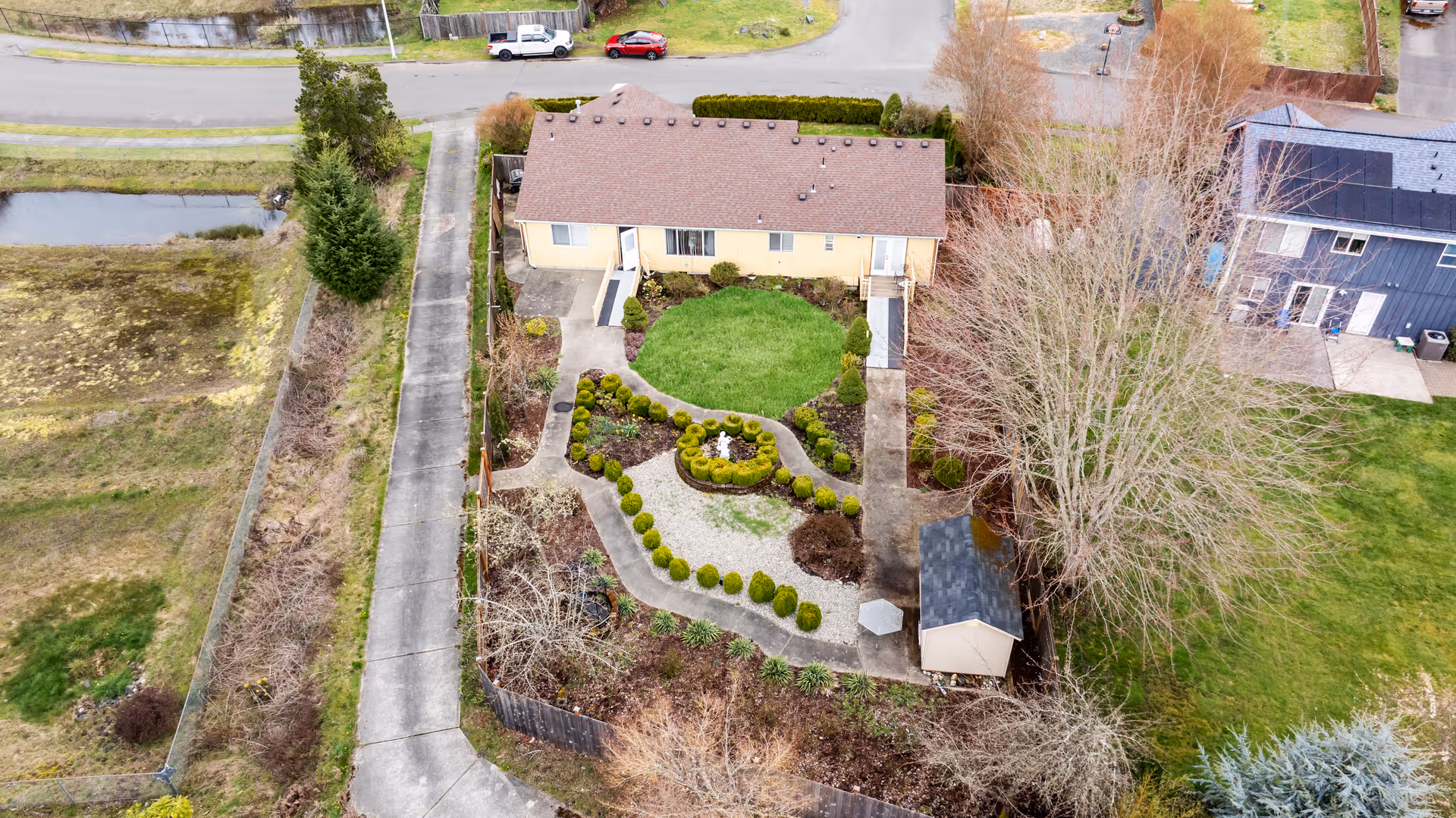 Aerial view of Santo Nino AFH building front with landscaped garden and surrounding homes