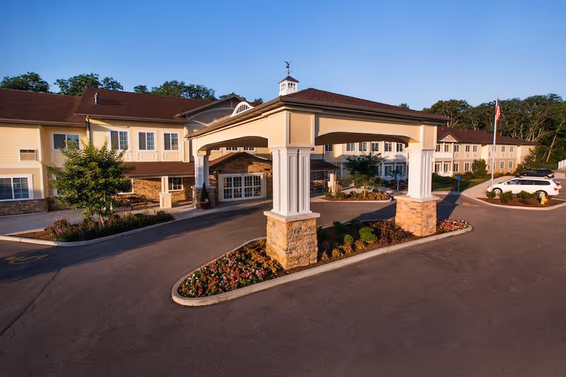 Exterior view of Westview at Ellisville Assisted Living with a covered entrance and landscaping.