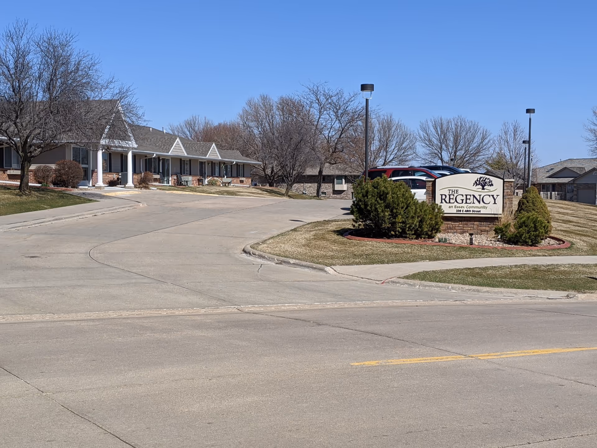 Exterior view of The Regency senior living campus with a sign and front buildings.