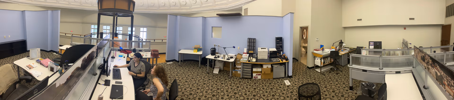 Open office area with cubicles and staff working at desks in Private Home Care