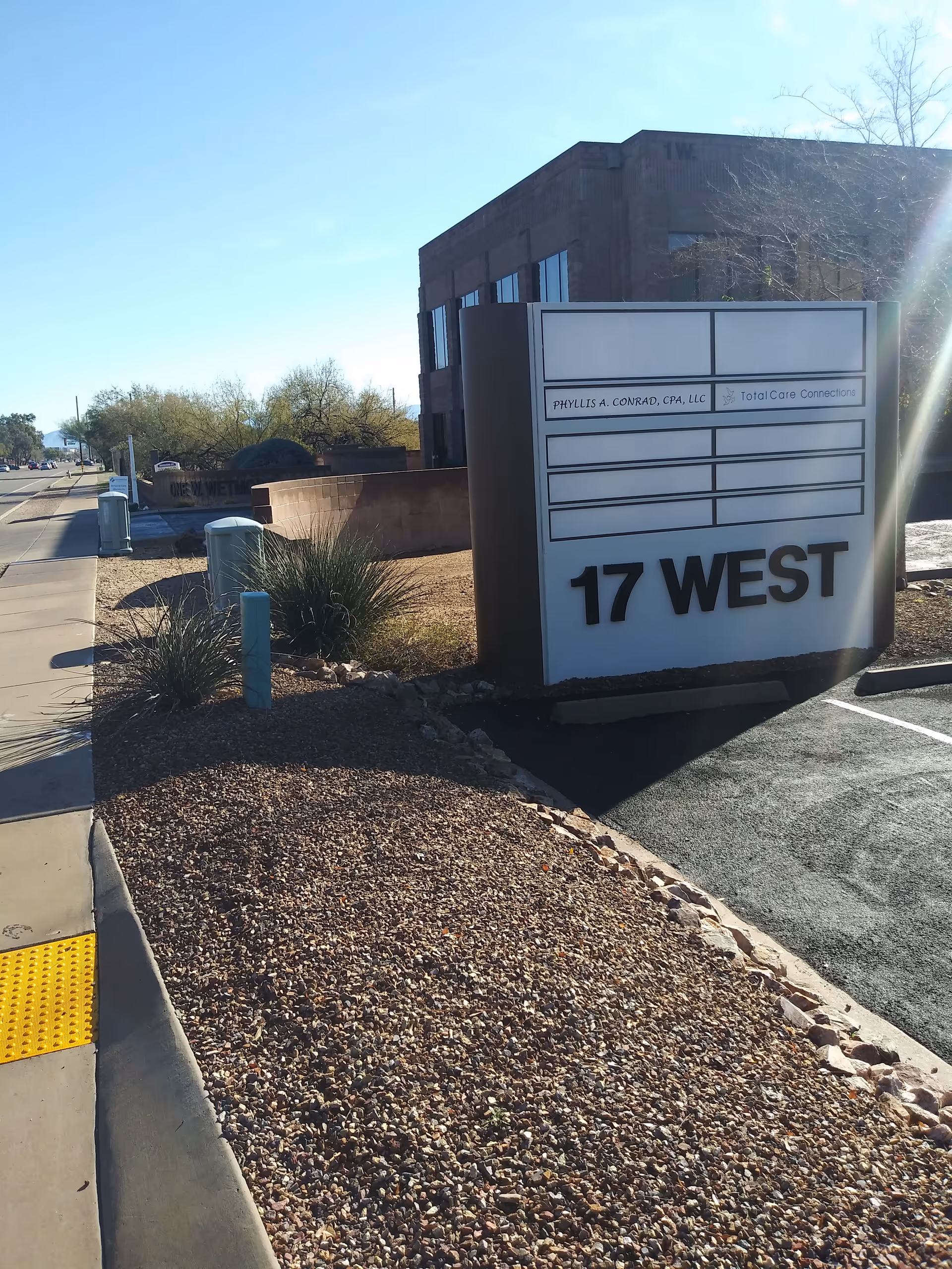 Exterior view of the Total Care Connections sign with 17 West in front of the building
