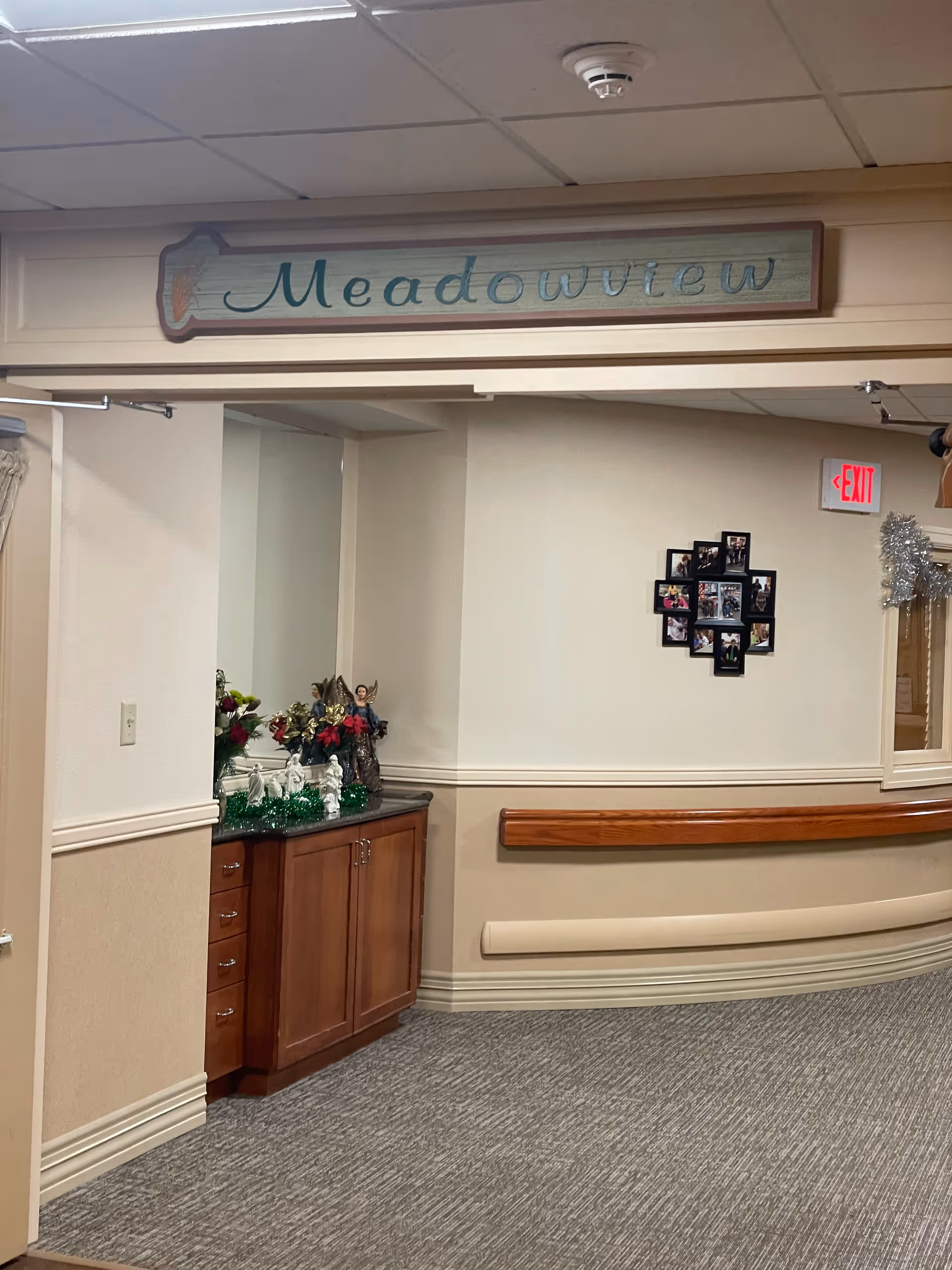 Interior hallway featuring Meadowview sign and a wooden sideboard display.