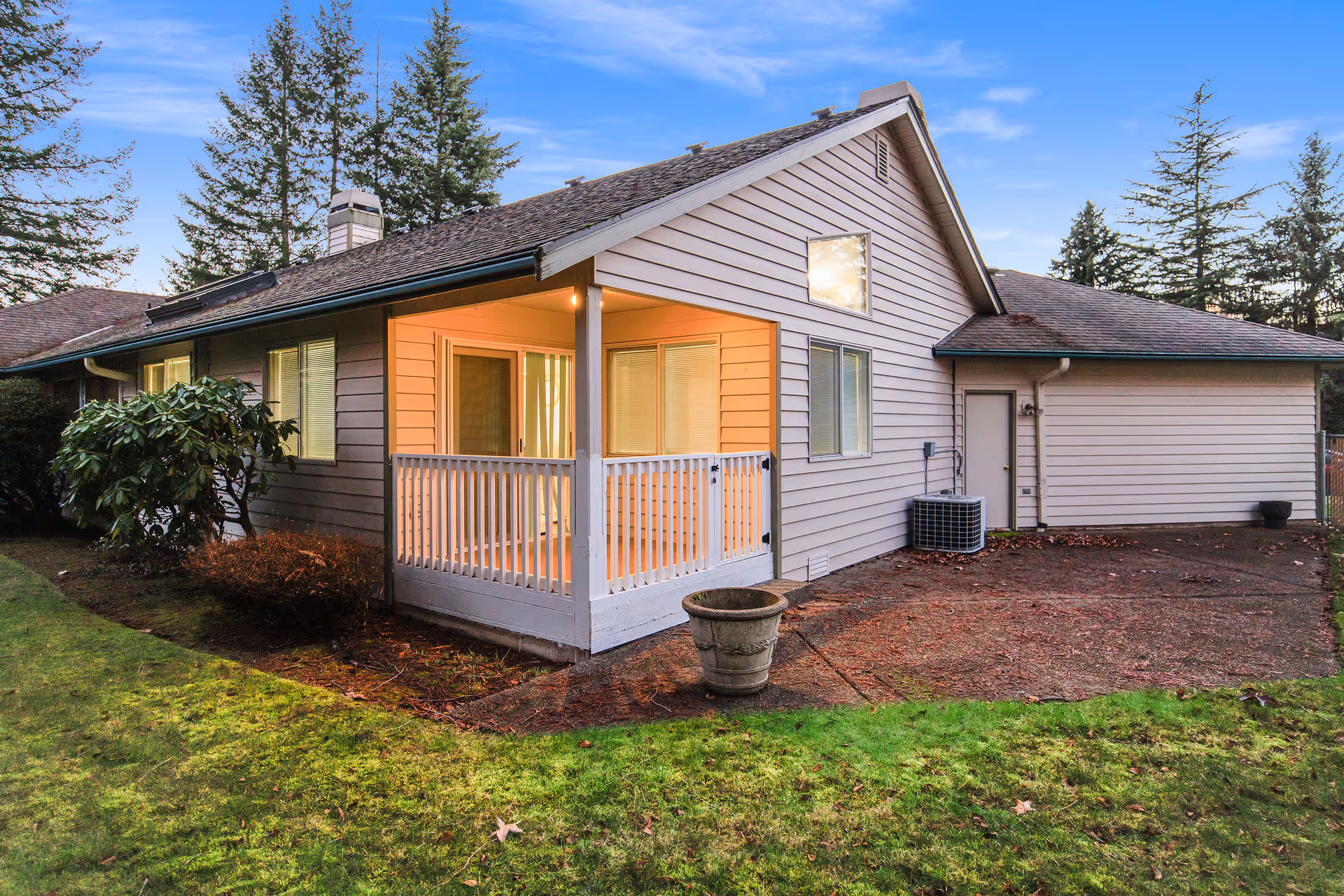Front view of a single-story adult family home with a covered porch and yard.