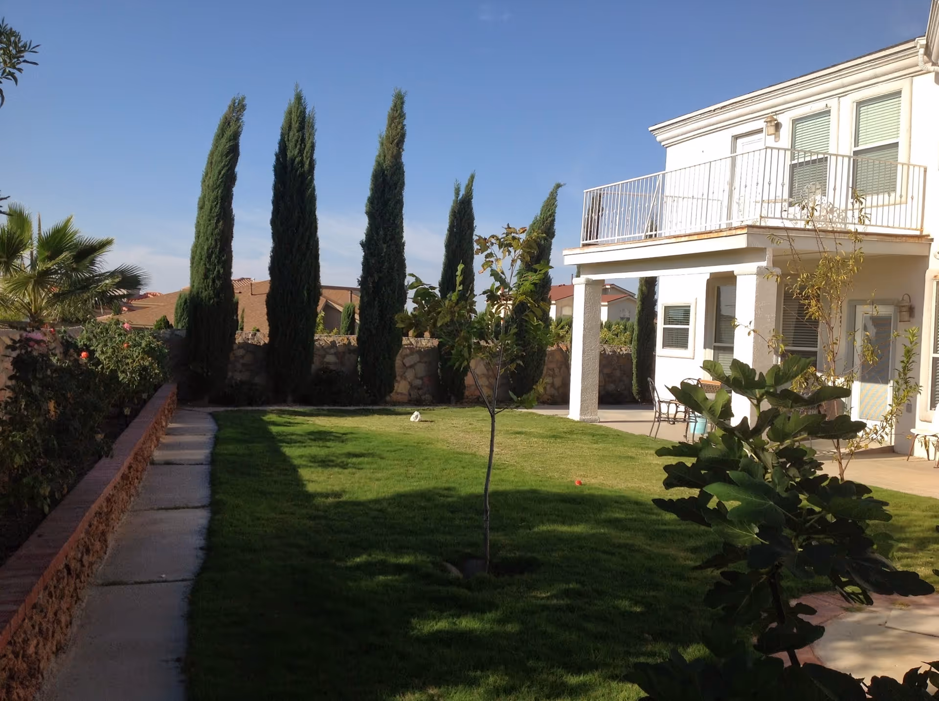 Exterior view of Angel's Heaven Adult Foster Home with a green lawn and balcony.
