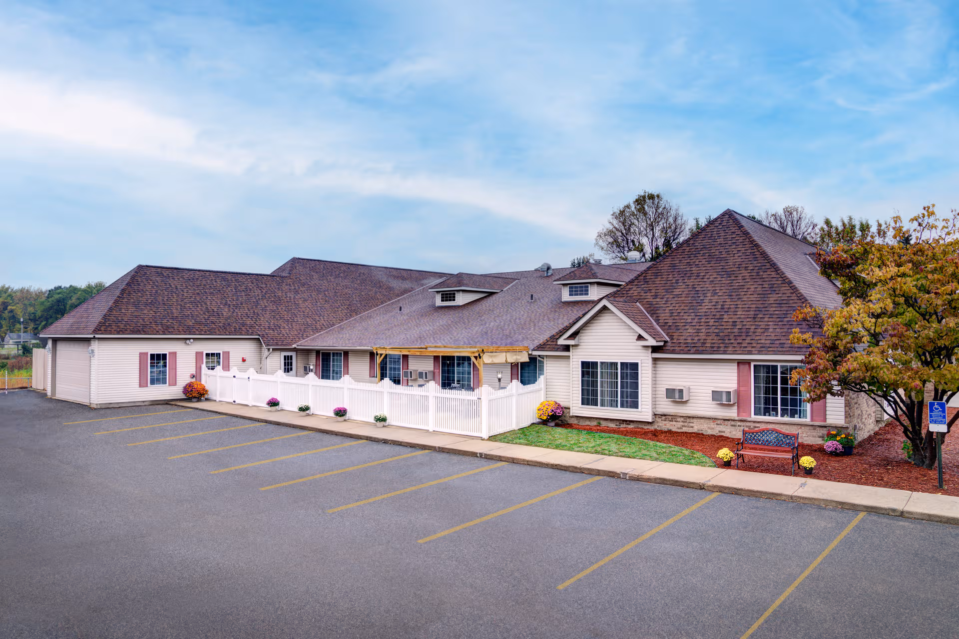 Exterior of Arlington Place of St Joseph, a single-story senior facility with pink shutters.
