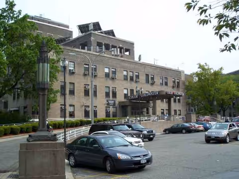 Front exterior view of Coler Rehabilitation and Nursing Care Center with parked cars.