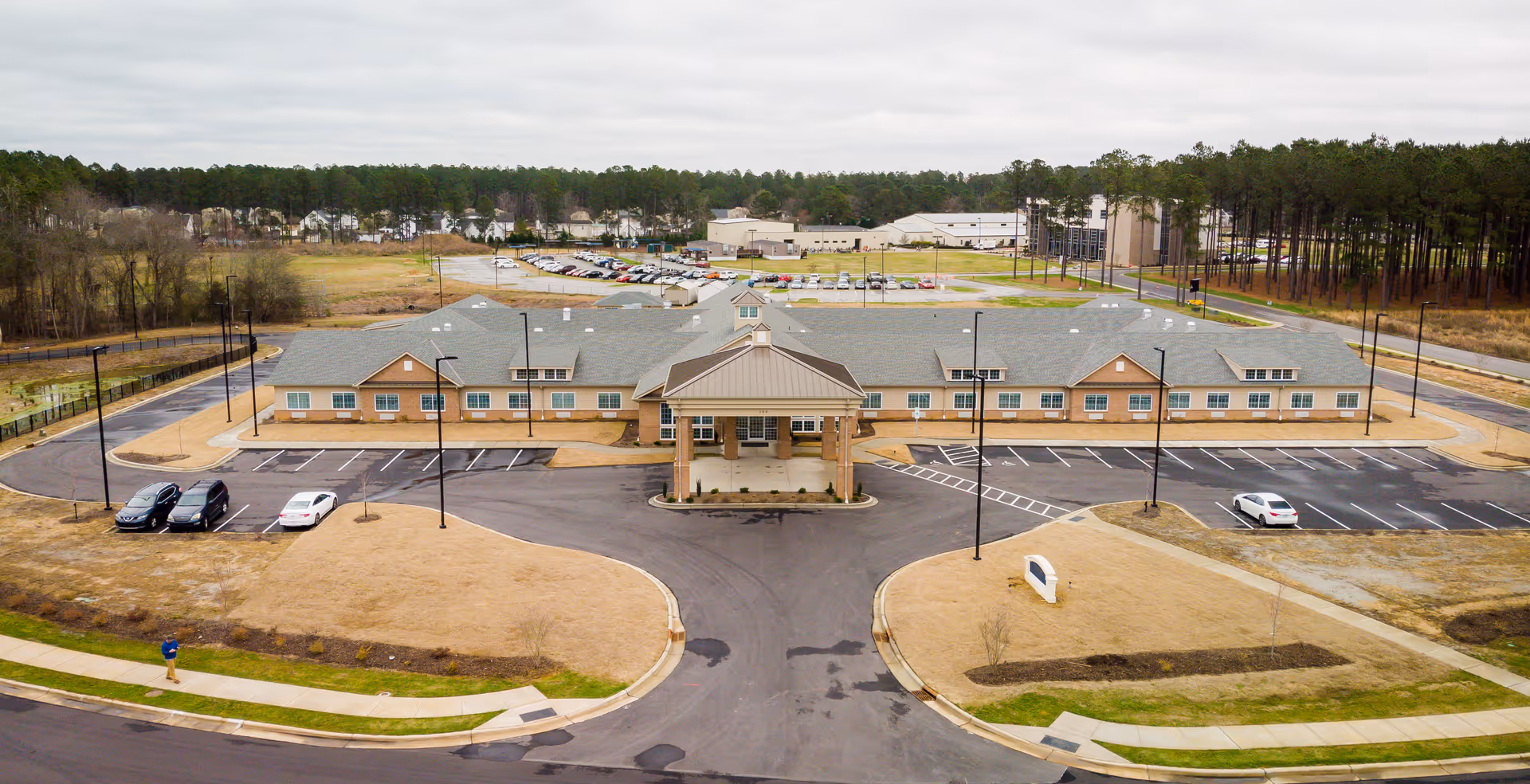 Aerial view of The Landings of Smithfield exterior with curved driveway and parking lot
