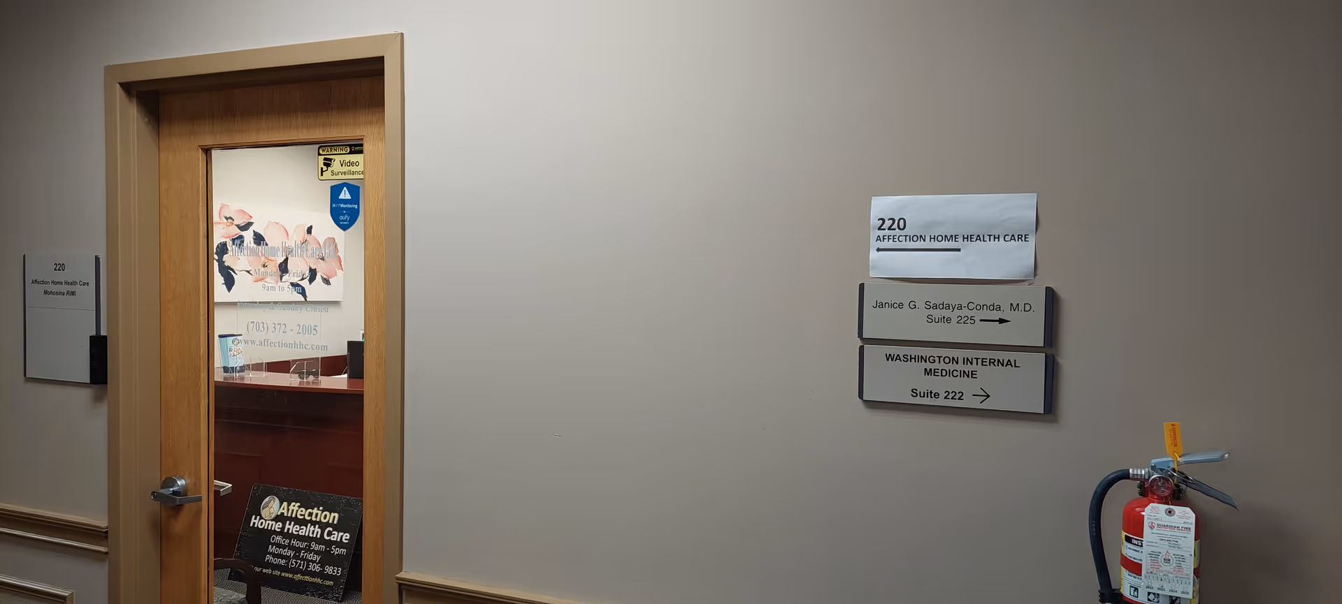 Hallway inside Affection Home Health Care facility with door, signs, and fire extinguisher.