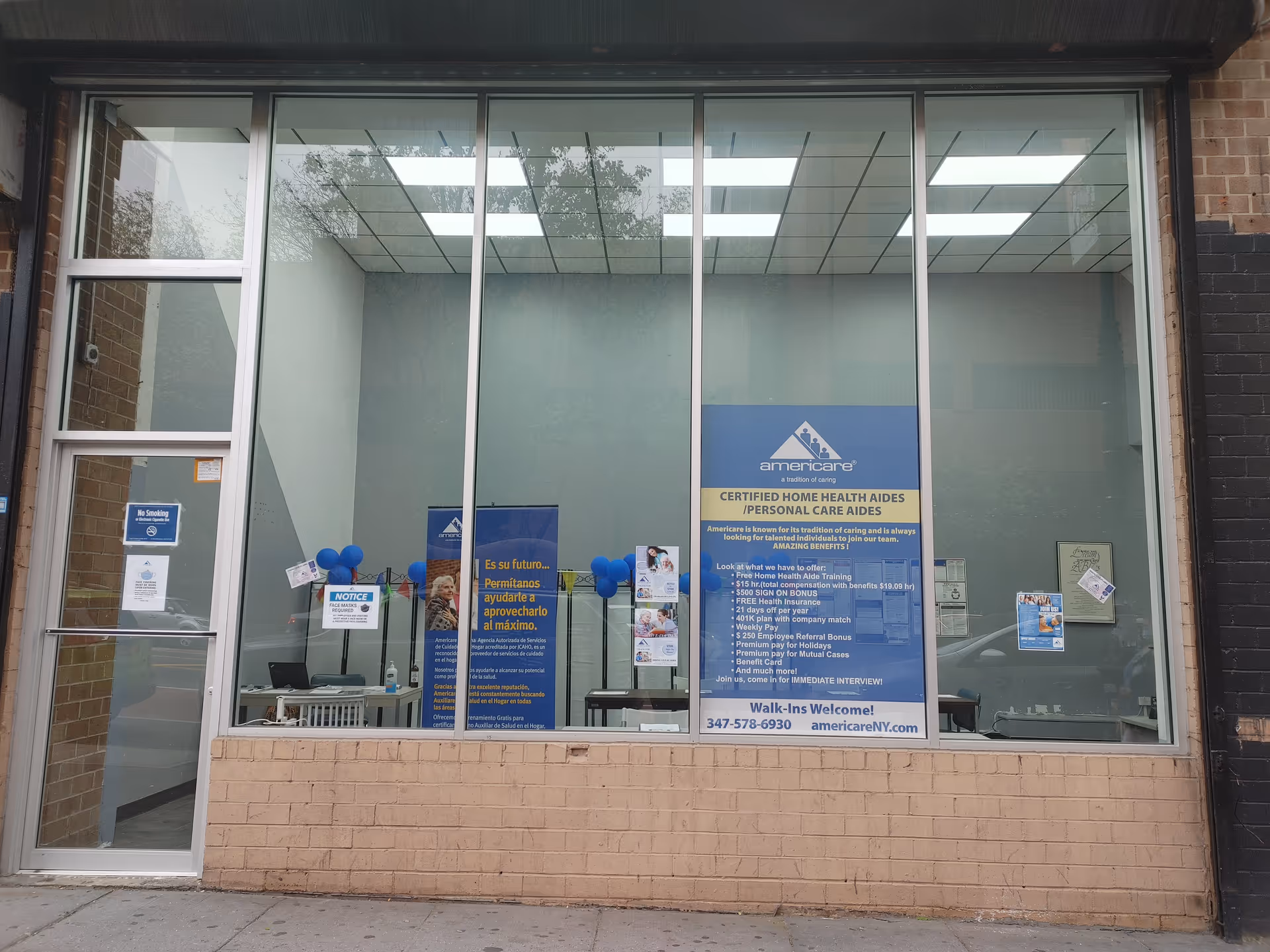 Glass storefront of Americare Coleman Street showing posters and a reception desk inside.