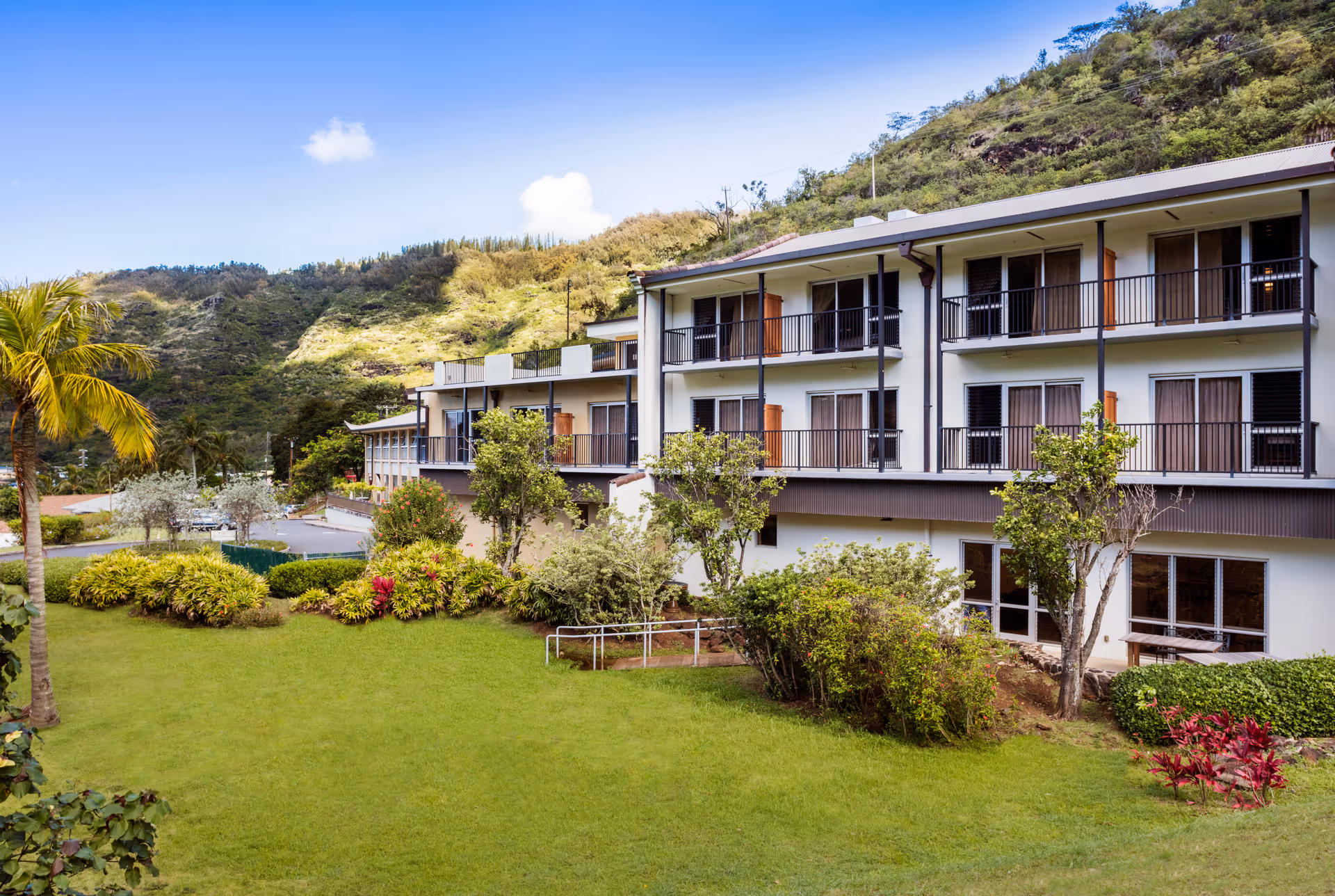 Exterior view of Palolo Chinese Home Lani Booth with balconies and landscaped grounds.