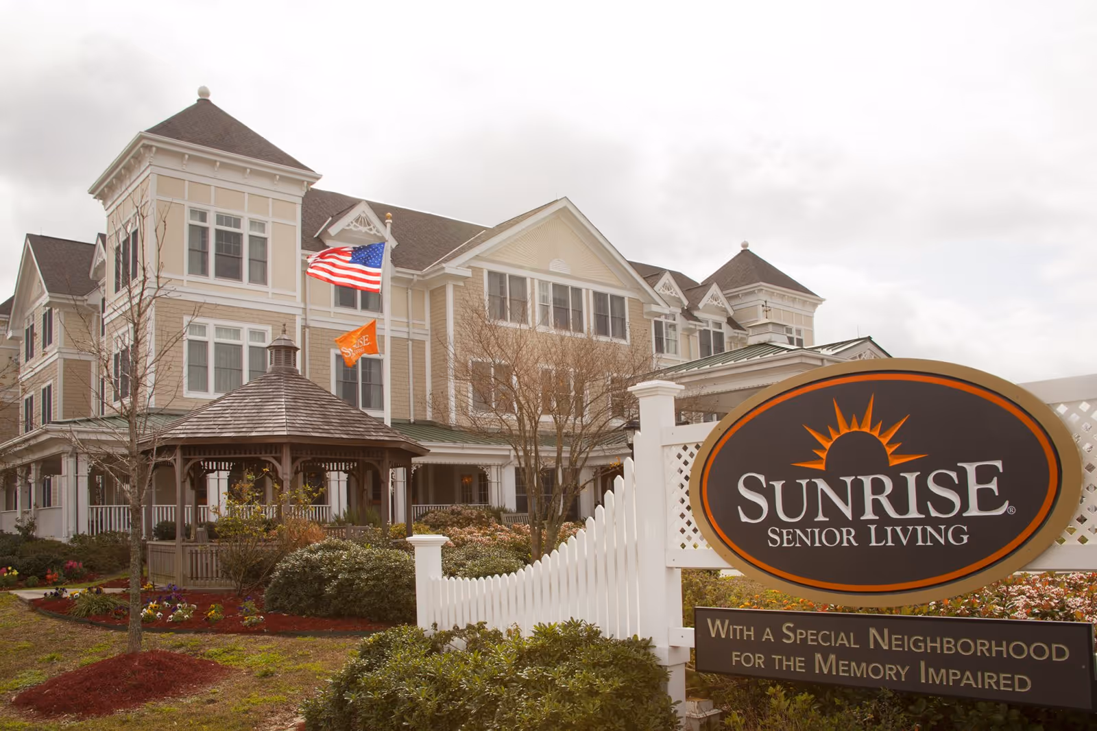 Sunrise Senior Living building exterior with gazebo, landscaped front yard, and a large front sign.