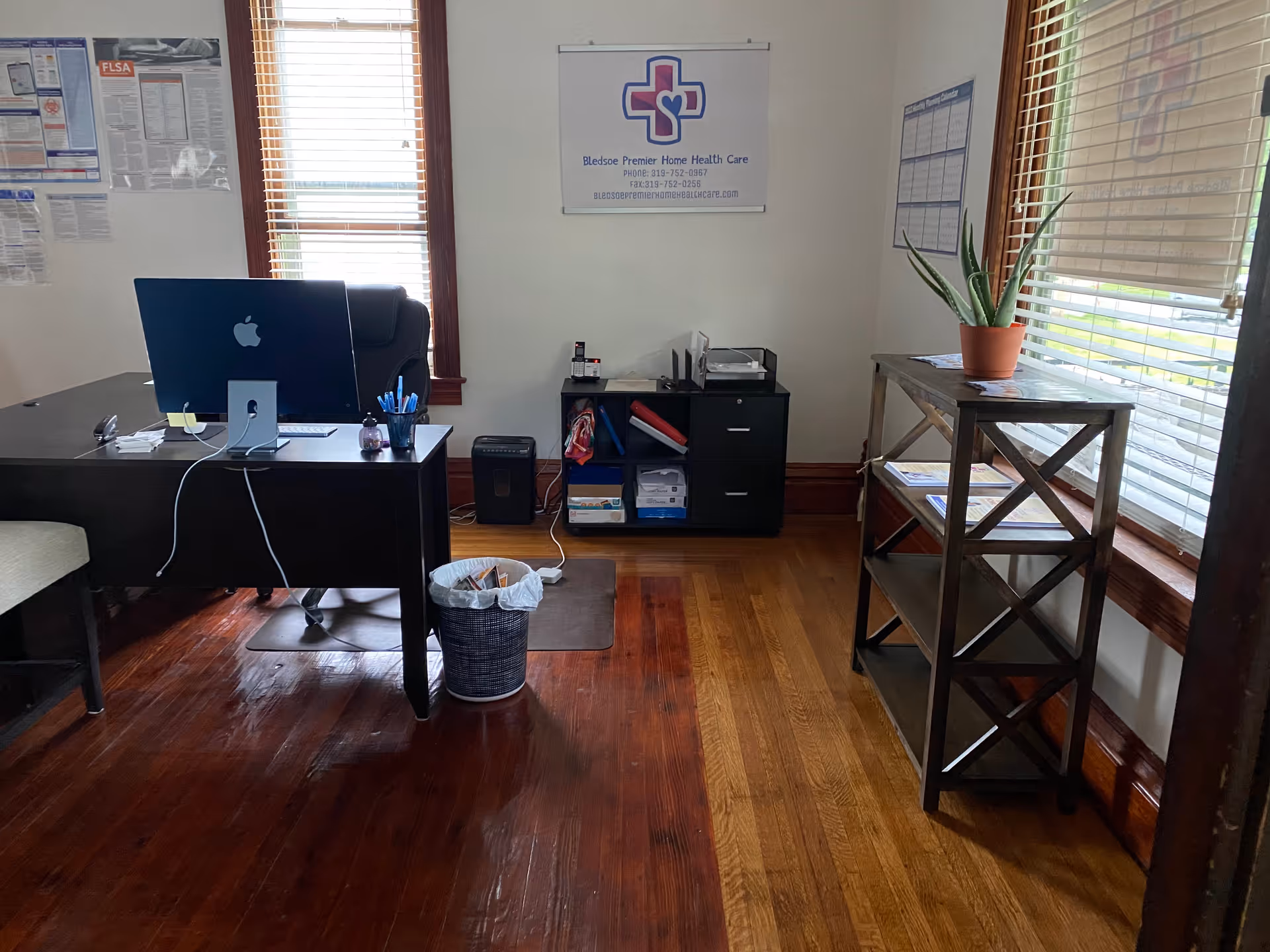 Office desk with computer, plant, and filing cabinet in a Bledsoe Premier Home Health Care office.