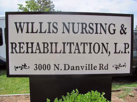 Outdoor sign for Willis Nursing & Rehabilitation, L.P. located at 3000 N. Danville Rd, with grass and a tree in the background.