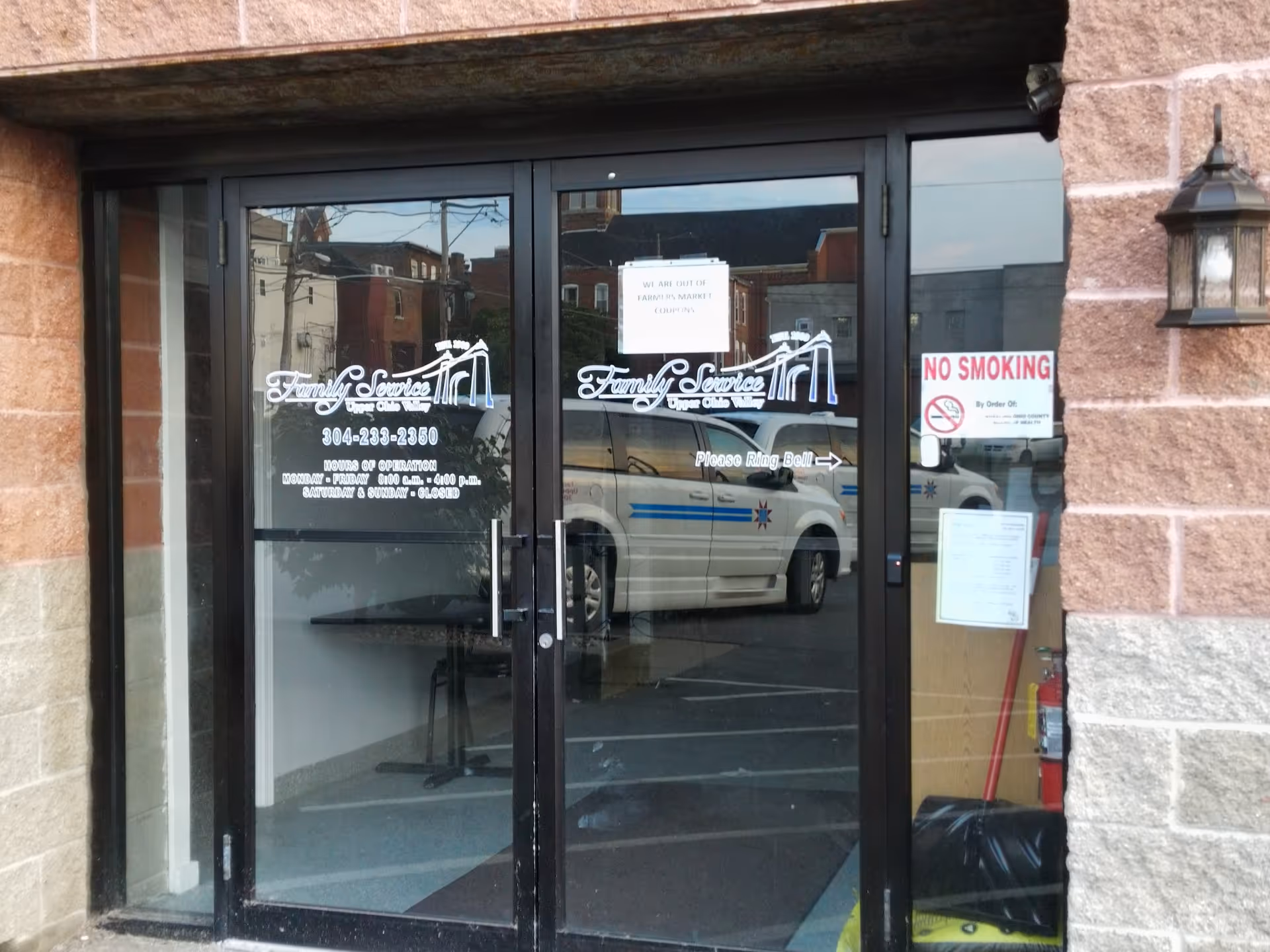 Glass storefront doors with Family Service logo and a No Smoking sign