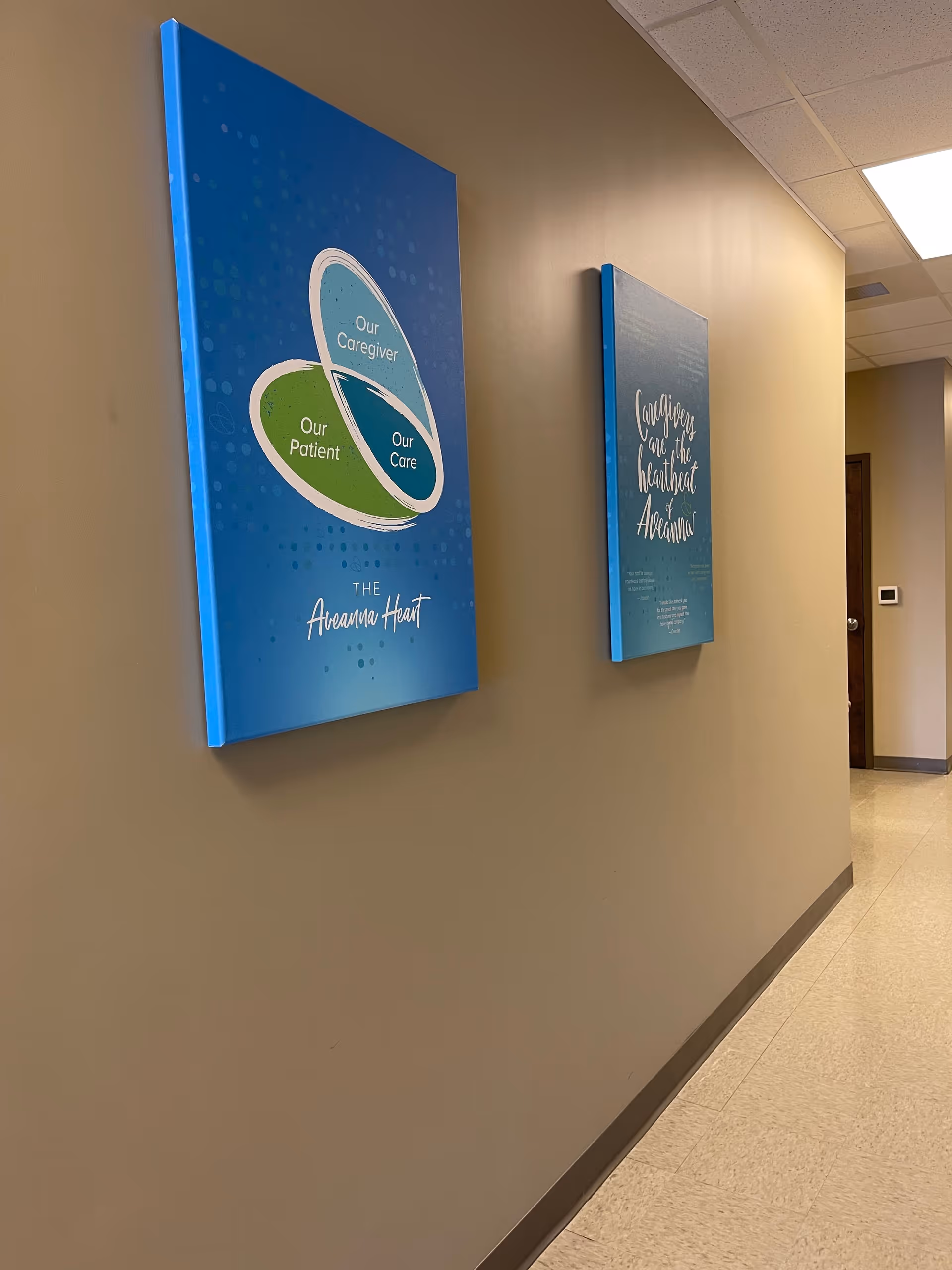 Hallway with blue wall art panels in a beige interior.