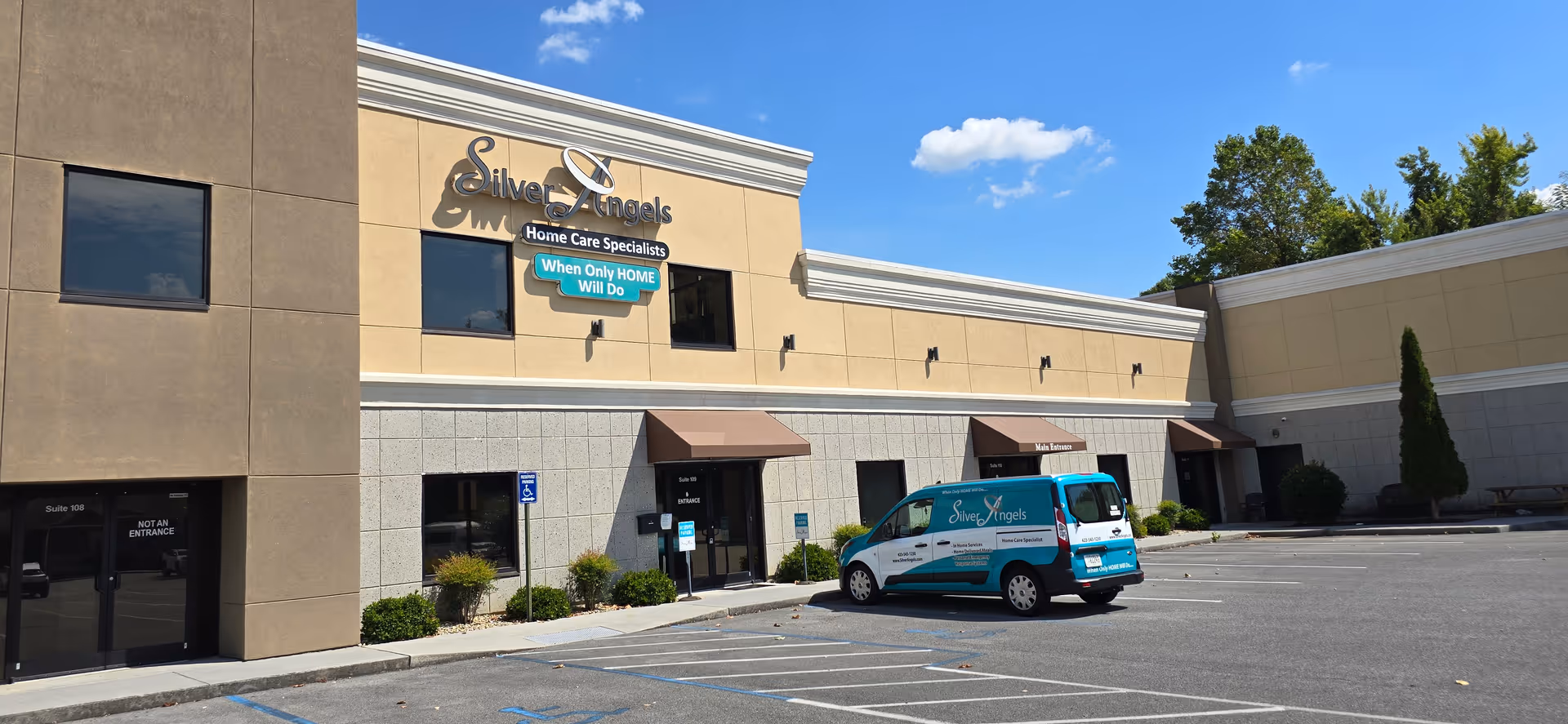 Exterior view of Silver Angels of Tennessee building with a teal delivery van in parking lot.